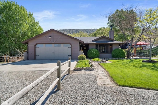 ranch-style home featuring concrete driveway, a garage, and a chimney