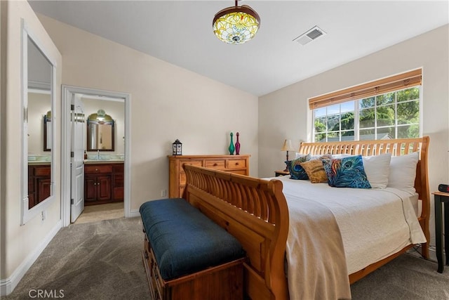bedroom with light colored carpet, ensuite bathroom, a sink, and baseboards