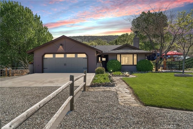 single story home with driveway, a garage, and a chimney