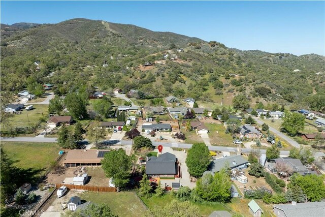 view of property location featuring a mountain backdrop and nearby suburban area