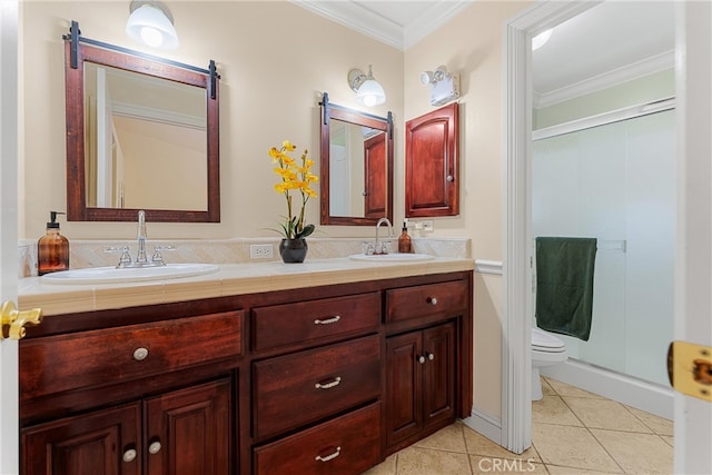 full bathroom featuring tile patterned floors, crown molding, toilet, a shower stall, and double vanity