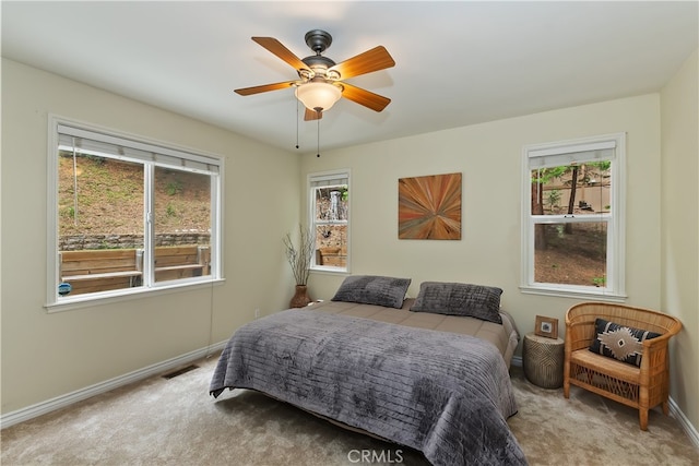 28589 Shenandoah Dr, Lake Arrowhead, CA 92352 - carpeted bedroom featuring multiple windows, baseboards, and ceiling fan