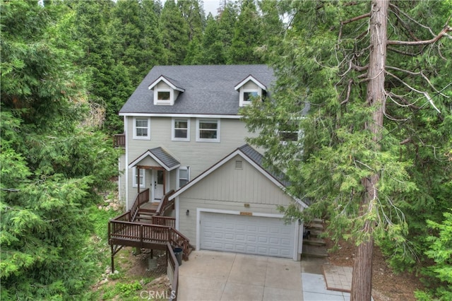 28589 Shenandoah Dr, Lake Arrowhead, CA 92352 - view of front of house featuring concrete driveway, a garage, and roof with shingles