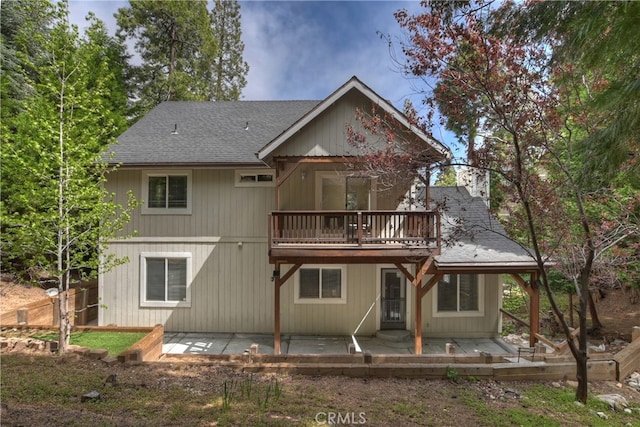 28589 Shenandoah Dr, Lake Arrowhead, CA 92352 - back of house with a shingled roof, a patio, and a balcony
