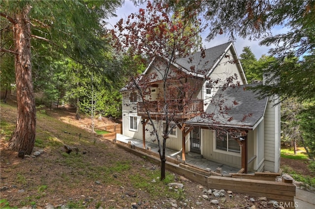 28589 Shenandoah Dr, Lake Arrowhead, CA 92352 - view of home's exterior featuring roof with shingles, a balcony, and covered porch