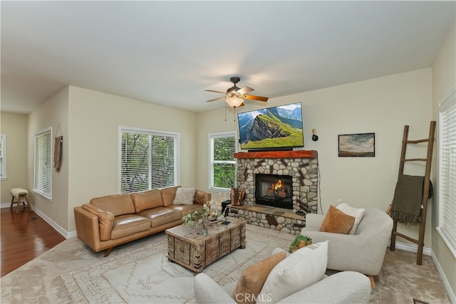 28589 Shenandoah Dr, Lake Arrowhead, CA 92352 - living area with ceiling fan, baseboards, a stone fireplace, and carpet floors