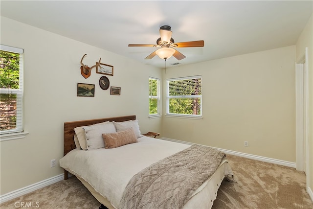 28589 Shenandoah Dr, Lake Arrowhead, CA 92352 - carpeted bedroom with multiple windows, baseboards, and ceiling fan