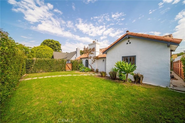 932 S Cloverdale Ave, Los Angeles, CA 90036 - rear view of house with a tile roof, stucco siding, and a chimney