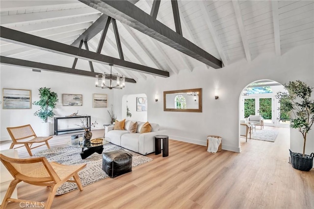 932 S Cloverdale Ave, Los Angeles, CA 90036 - living area featuring arched walkways, a chandelier, wood finished floors, and baseboards