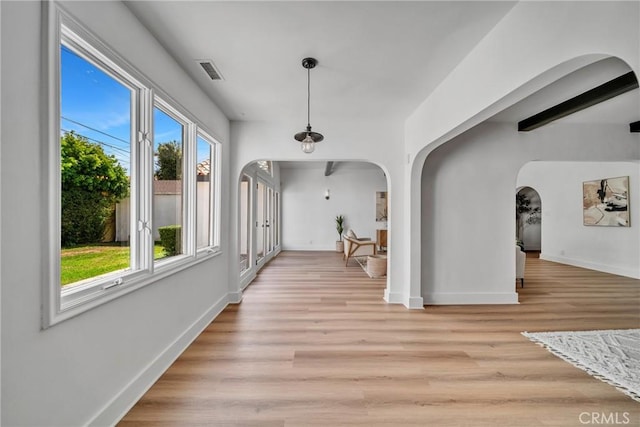 932 S Cloverdale Ave, Los Angeles, CA 90036 - hallway featuring arched walkways, baseboards, and light wood finished floors