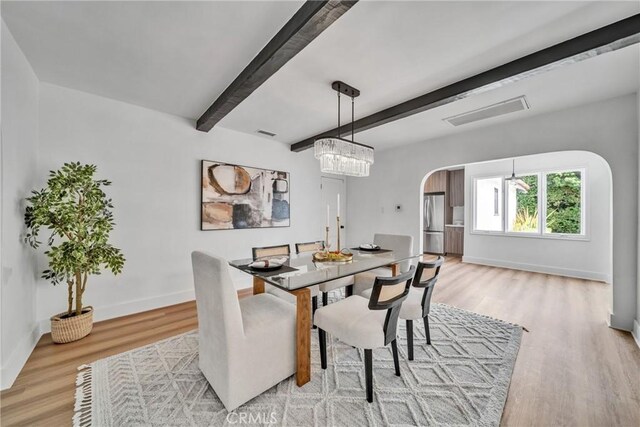 932 S Cloverdale Ave, Los Angeles, CA 90036 - dining room with arched walkways, beam ceiling, light wood-type flooring, and baseboards
