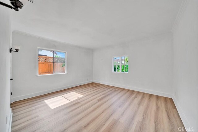 932 S Cloverdale Ave, Los Angeles, CA 90036 - empty room with light wood-type flooring, ornamental molding, and baseboards