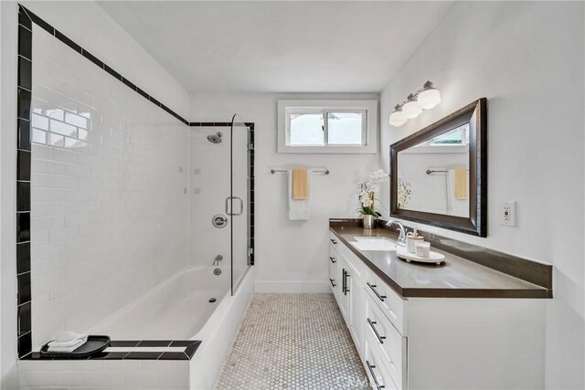 932 S Cloverdale Ave, Los Angeles, CA 90036 - full bath with vanity, combined bath / shower with glass door, tile patterned floors, and baseboards