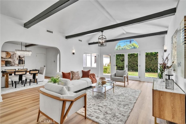 932 S Cloverdale Ave, Los Angeles, CA 90036 - living room with arched walkways, light wood-style floors, and a chandelier