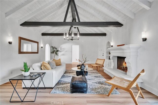 932 S Cloverdale Ave, Los Angeles, CA 90036 - living room with arched walkways, a chandelier, wood ceiling, and wood finished floors