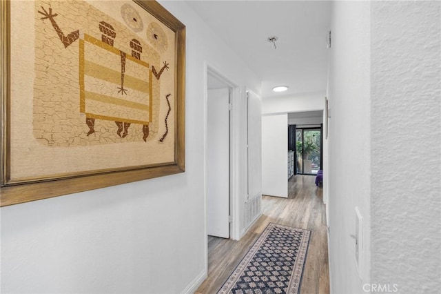 13429 Benbow St, Baldwin Park, CA 91706 - corridor featuring wood finished floors, baseboards, and recessed lighting