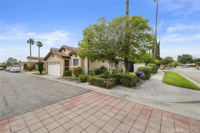 13429 Benbow St, Baldwin Park, CA 91706 - view of front of home with a garage, stucco siding, asphalt driveway, and a tile roof