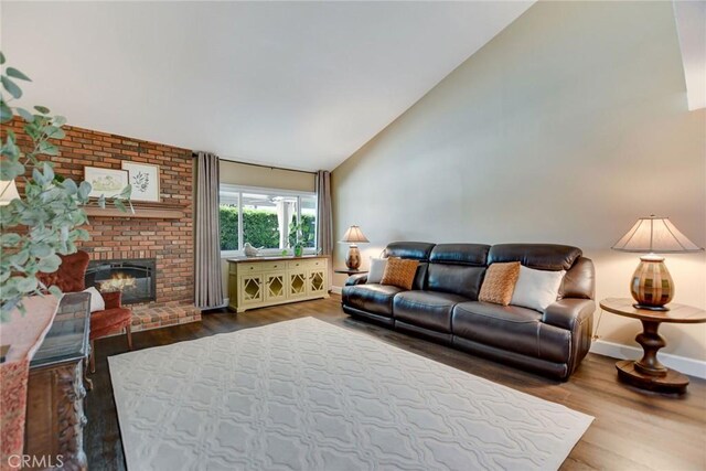 1298 Oak Ridge Dr, La Verne, CA 91750 - living area featuring wood finished floors, a brick fireplace, baseboards, and high vaulted ceiling