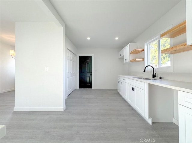 15811 S Tarrant Ave, Compton, CA 90220 - kitchen with a sink, open shelves, baseboards, white cabinetry, and recessed lighting