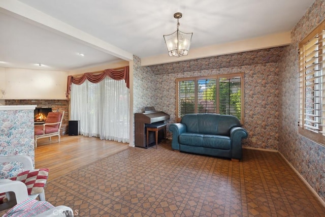 7861 Cora St, Sunland, CA 91040 - living area featuring a lit fireplace, beamed ceiling, and a chandelier
