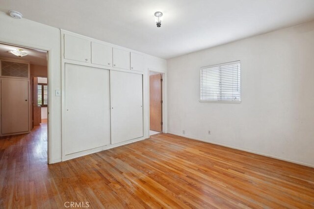 7861 Cora St, Sunland, CA 91040 - unfurnished bedroom with light wood finished floors and a closet