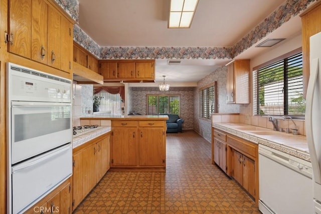 7861 Cora St, Sunland, CA 91040 - kitchen featuring white appliances, a warming drawer, a peninsula, plenty of natural light, and wallpapered walls