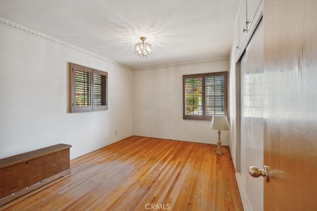 7861 Cora St, Sunland, CA 91040 - empty room with light wood-type flooring and a chandelier