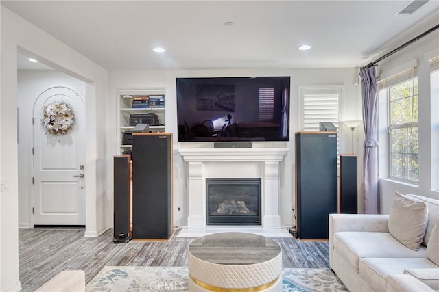 89 Baculo St, Rancho Mission Viejo, CA 92694 - living area featuring wood finished floors, a glass covered fireplace, and recessed lighting