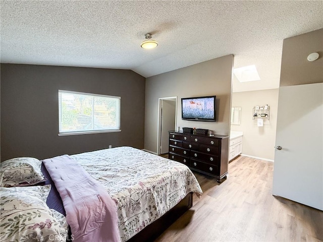26490 Mapleridge Way, Moreno Valley, CA 92555 - bedroom featuring light wood finished floors, vaulted ceiling, a skylight, a textured ceiling, and baseboards