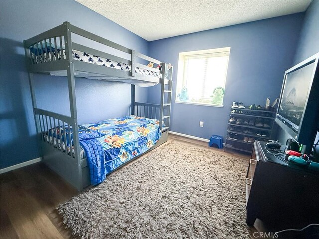 26490 Mapleridge Way, Moreno Valley, CA 92555 - bedroom with wood finished floors, baseboards, and a textured ceiling