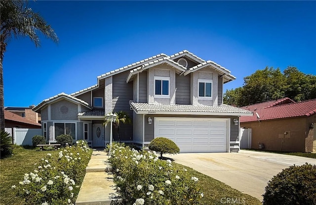 26490 Mapleridge Way, Moreno Valley, CA 92555 - traditional home featuring a tiled roof, driveway, an attached garage, and stucco siding