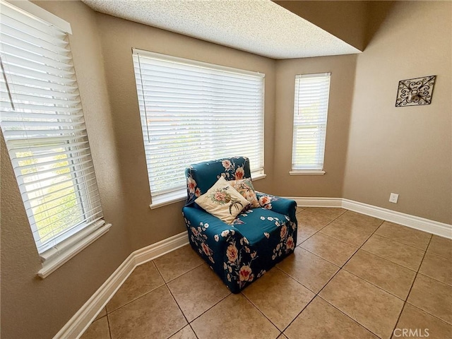 26490 Mapleridge Way, Moreno Valley, CA 92555 - living area with tile patterned flooring, baseboards, and a textured ceiling