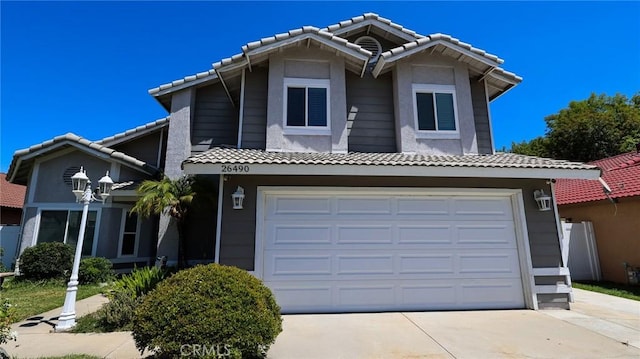 26490 Mapleridge Way, Moreno Valley, CA 92555 - view of front facade with concrete driveway, a tiled roof, and a garage