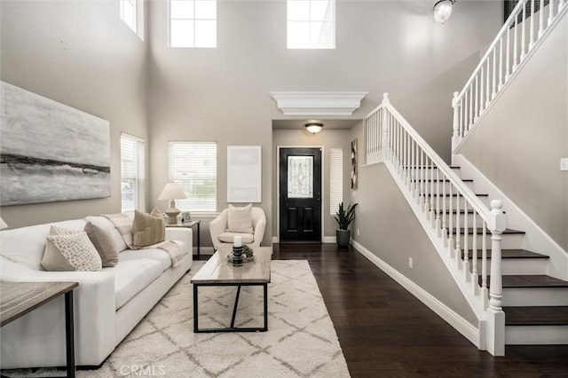 27917 Busman Rd, Murrieta, CA 92563 - living area with a towering ceiling, healthy amount of natural light, wood finished floors, stairs, and baseboards