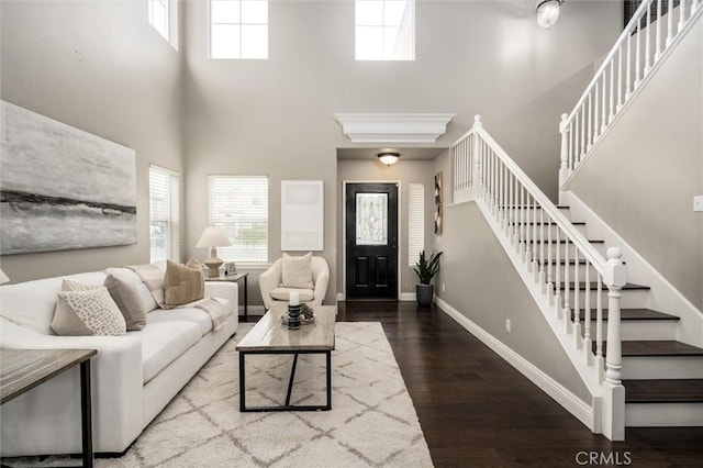 27917 Busman Rd, Murrieta, CA 92563 - living room with a high ceiling, healthy amount of natural light, wood finished floors, and stairs