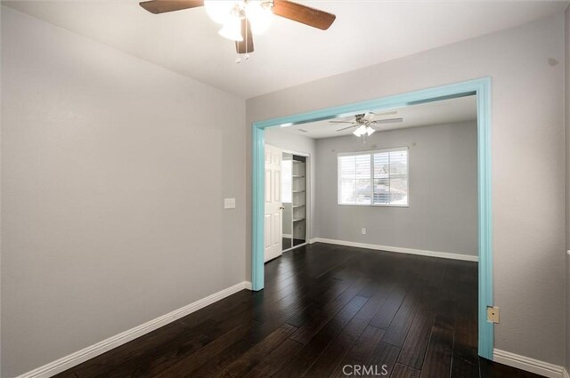 27917 Busman Rd, Murrieta, CA 92563 - unfurnished room with a ceiling fan, dark wood-style flooring, and baseboards