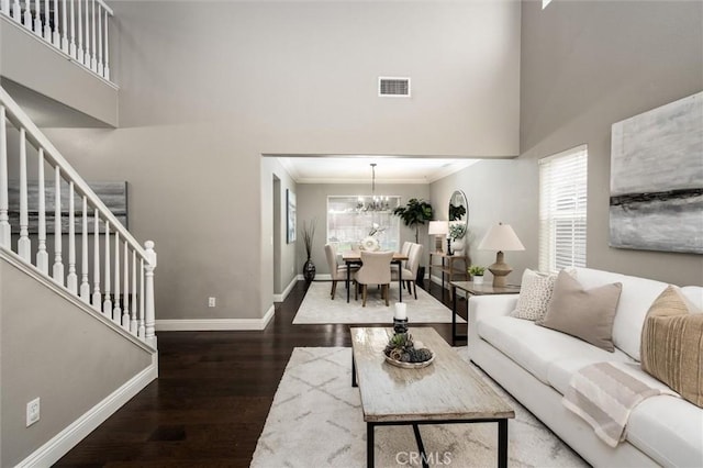 27917 Busman Rd, Murrieta, CA 92563 - living area featuring a high ceiling, baseboards, wood finished floors, stairs, and crown molding