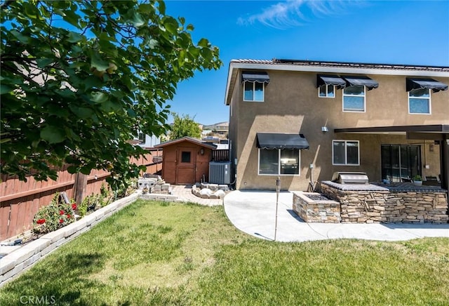27917 Busman Rd, Murrieta, CA 92563 - rear view of house featuring stucco siding, an outdoor kitchen, a patio, and a shed