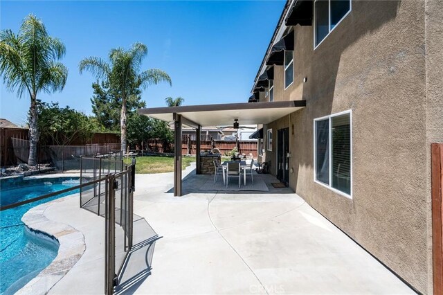 27917 Busman Rd, Murrieta, CA 92563 - view of swimming pool with a ceiling fan, a fenced backyard, a patio area, and outdoor dining space
