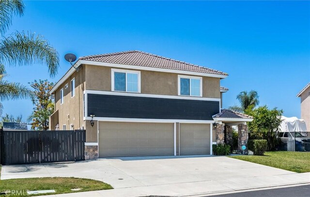27917 Busman Rd, Murrieta, CA 92563 - traditional-style house with stucco siding, an attached garage, stone siding, a tile roof, and driveway