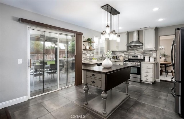 27917 Busman Rd, Murrieta, CA 92563 - kitchen with wall chimney exhaust hood, appliances with stainless steel finishes, backsplash, hanging light fixtures, and baseboards