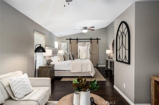 27917 Busman Rd, Murrieta, CA 92563 - bedroom featuring vaulted ceiling, dark wood-style flooring, a barn door, and a ceiling fan