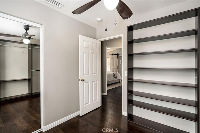 27917 Busman Rd, Murrieta, CA 92563 - unfurnished bedroom with a closet, dark wood-type flooring, and a ceiling fan