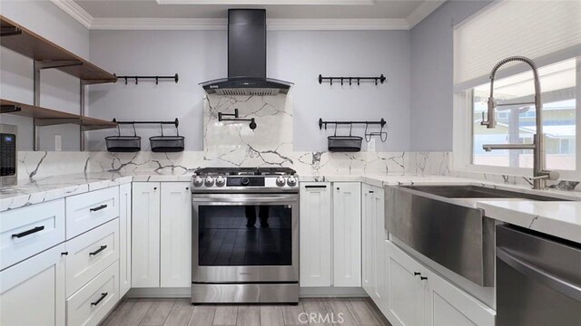27533 Caraway Ln, Saugus, CA 91350 - kitchen with appliances with stainless steel finishes, wall chimney range hood, open shelves, crown molding, and backsplash