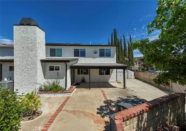 27533 Caraway Ln, Saugus, CA 91350 - back of property featuring a patio area, a fenced backyard, and stucco siding