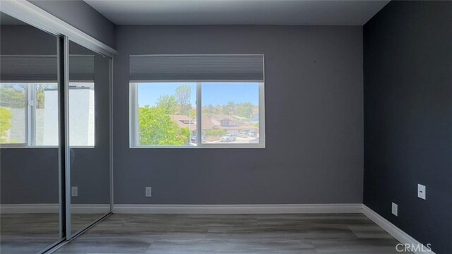 27533 Caraway Ln, Saugus, CA 91350 - empty room with healthy amount of natural light and wood finished floors