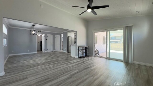 27533 Caraway Ln, Saugus, CA 91350 - unfurnished living room featuring plenty of natural light, ornamental molding, ceiling fan, and wood finished floors