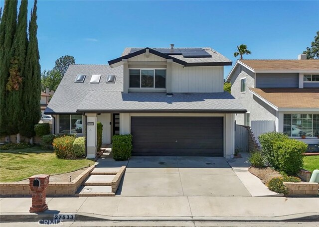27533 Caraway Ln, Saugus, CA 91350 - view of front of property with roof mounted solar panels, driveway, a garage, and a front yard