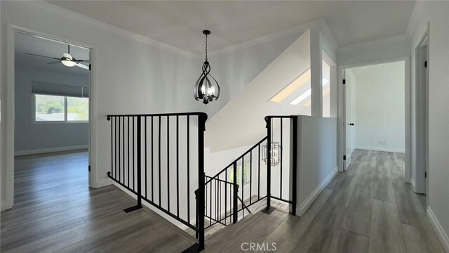 27533 Caraway Ln, Saugus, CA 91350 - hallway featuring an upstairs landing, wood finished floors, a chandelier, and ornamental molding