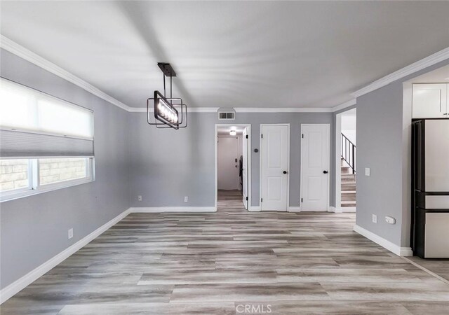 27533 Caraway Ln, Saugus, CA 91350 - unfurnished room featuring stairway, light wood-style flooring, and crown molding